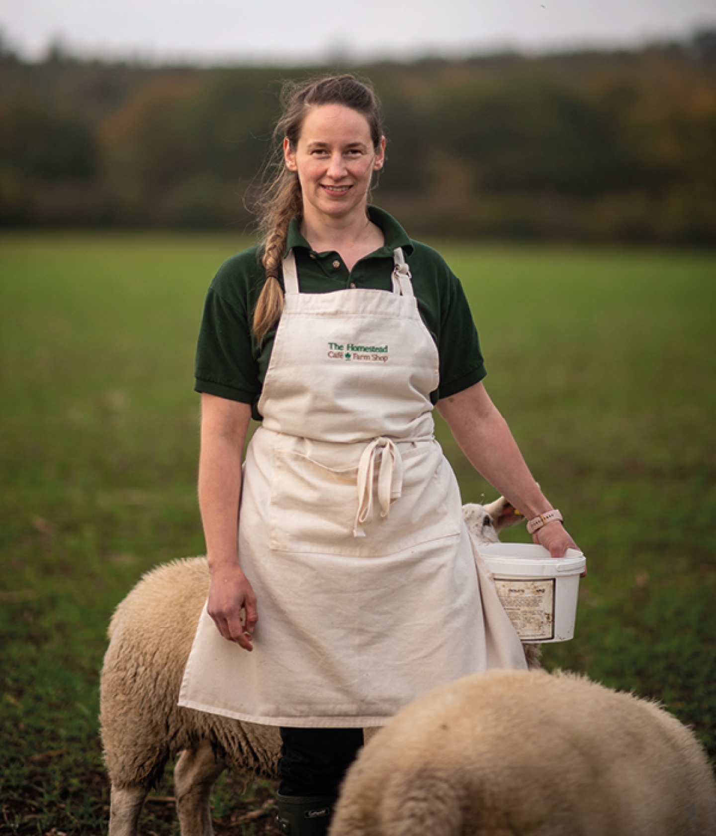 farmer standing amongst her sheep