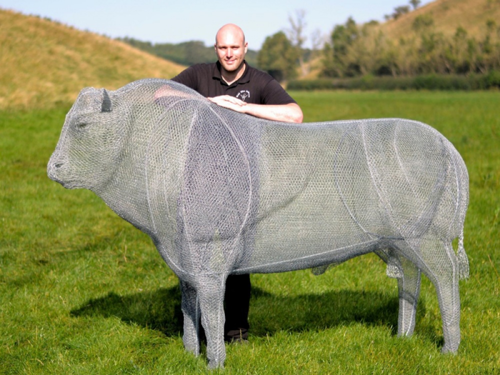 Richard standing with a bull sculpture