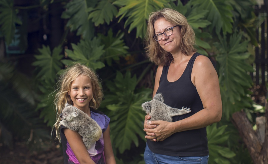 Ali Bee and daughter holding koalas