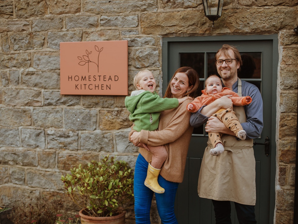 family stood outside their restaurant