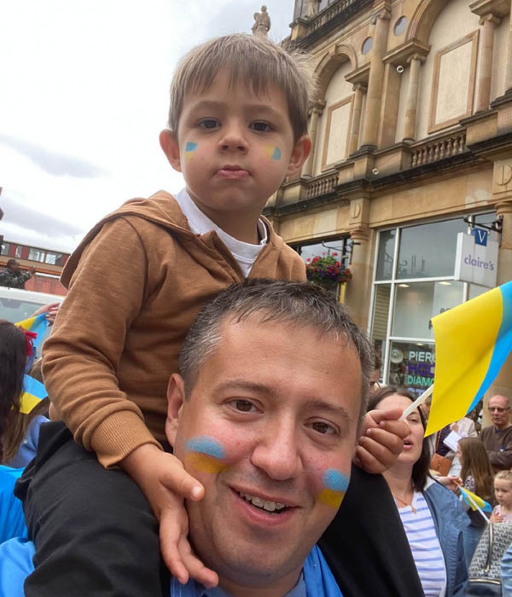 child on dads shoulders
