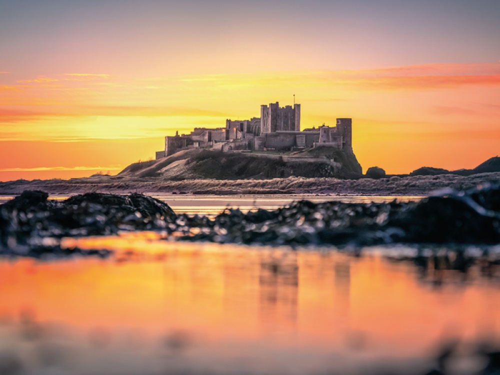 castle on a beach at sunset