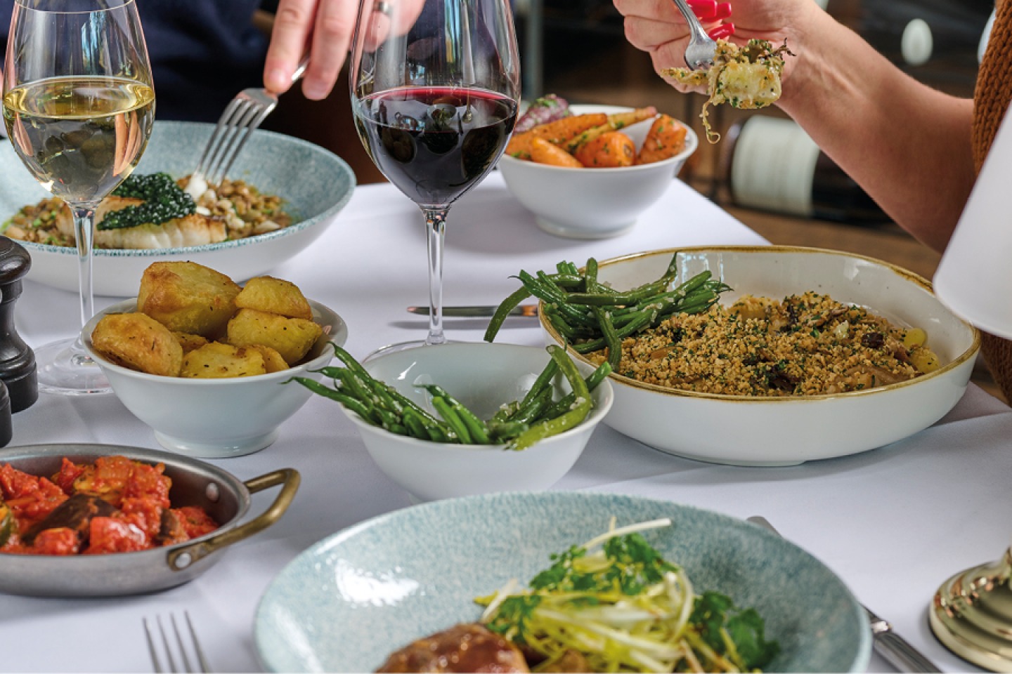 bowls of food and glasses of wine