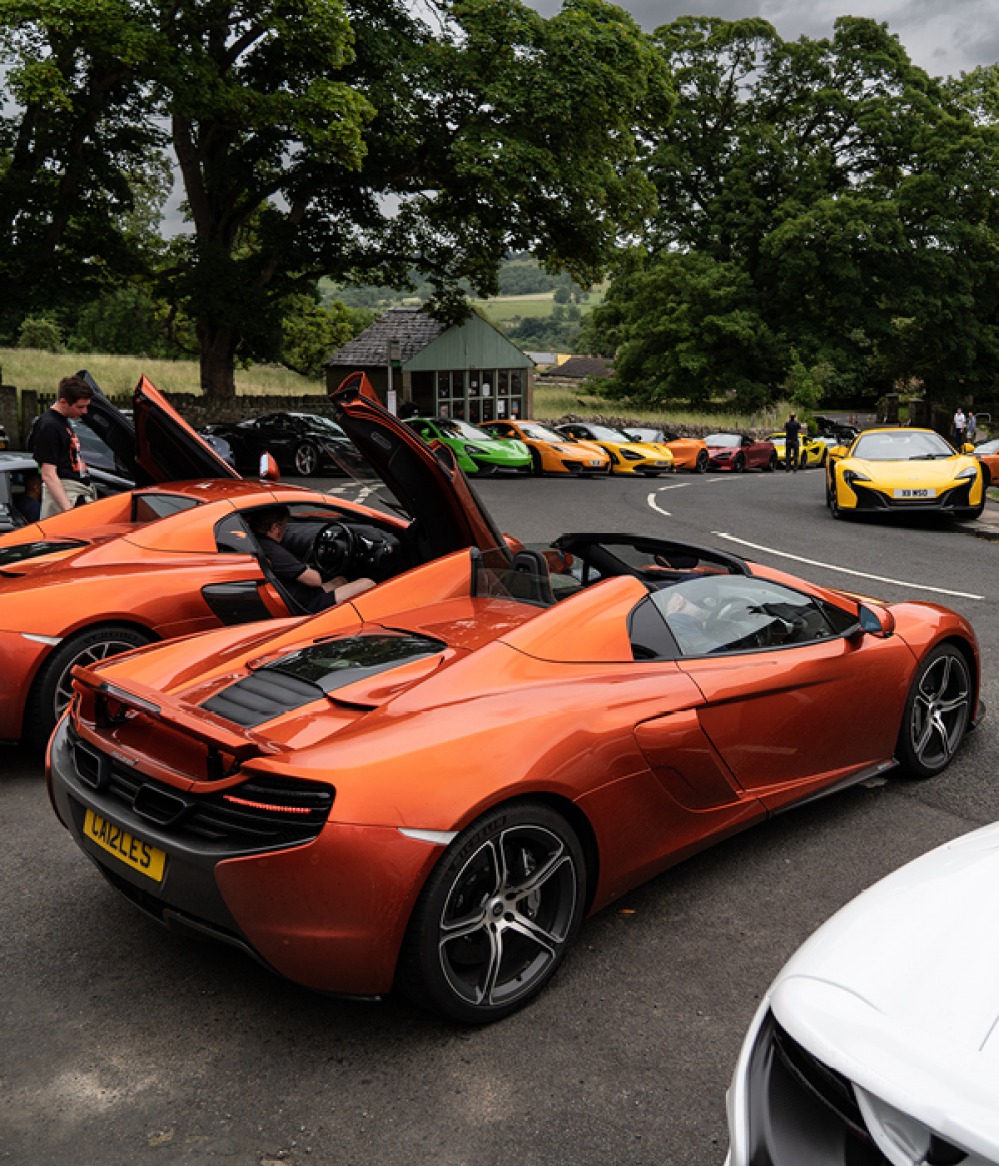 Mclaren cars in different colours lined up at the Meet at the Crown Inn
