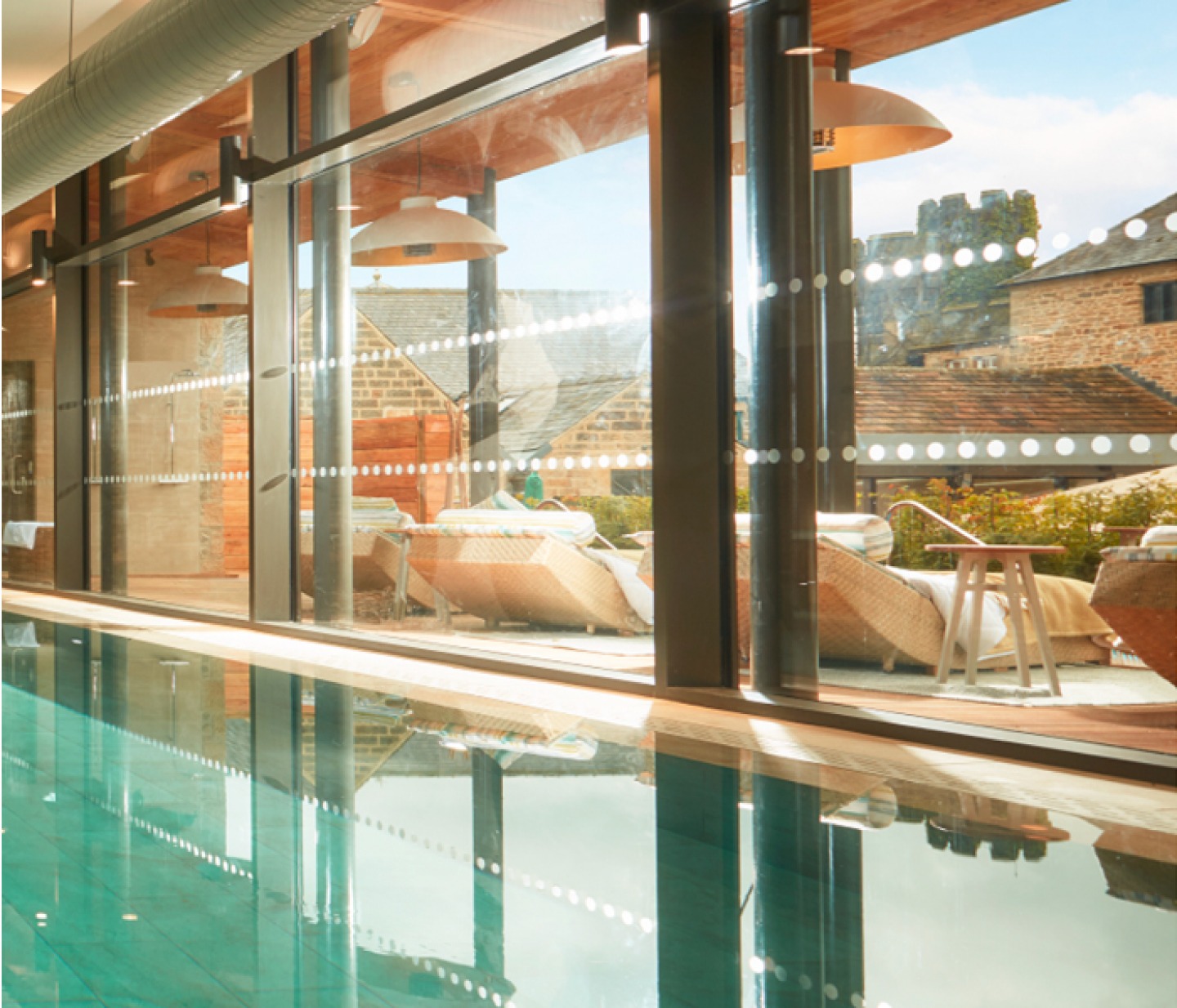 Swimming pool looking to outdoor seating at Swinton Park, Yorkshire