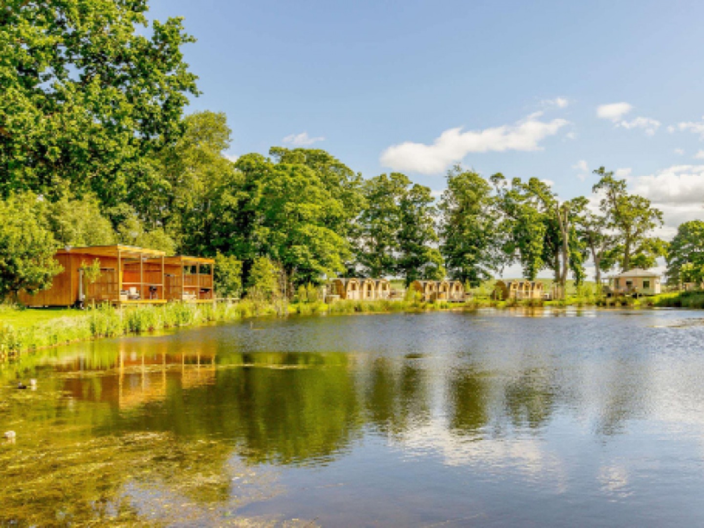 Lake with wooden cabins along the edge