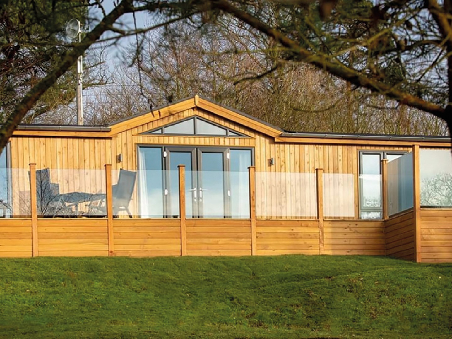 Pine lodge with large glass balcony