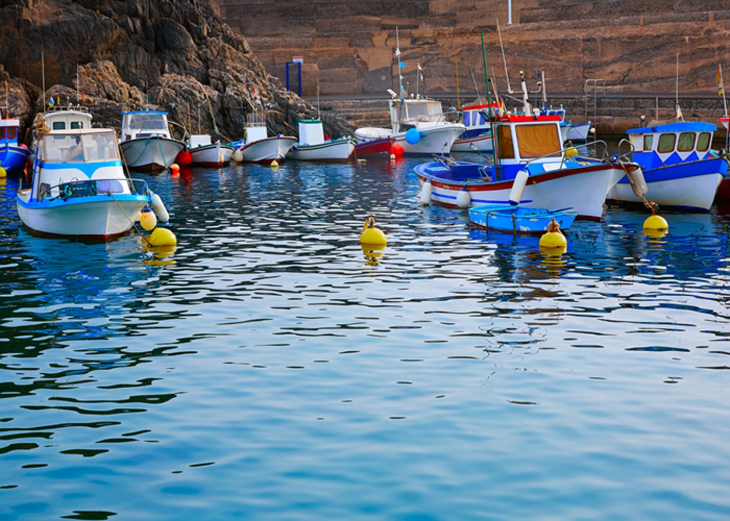 Harbour and boats with cliffs in background