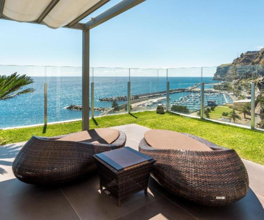 Rattan Loungers on a balcony looking over harbour