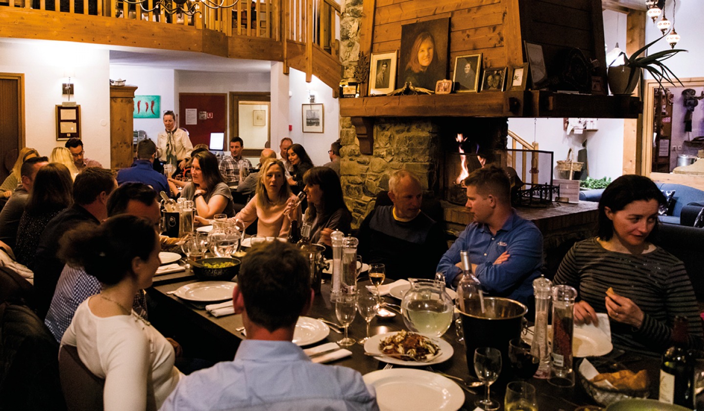 guest sitting around a large table for dinner