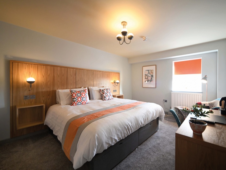 orange coloured bedroom in a hotel