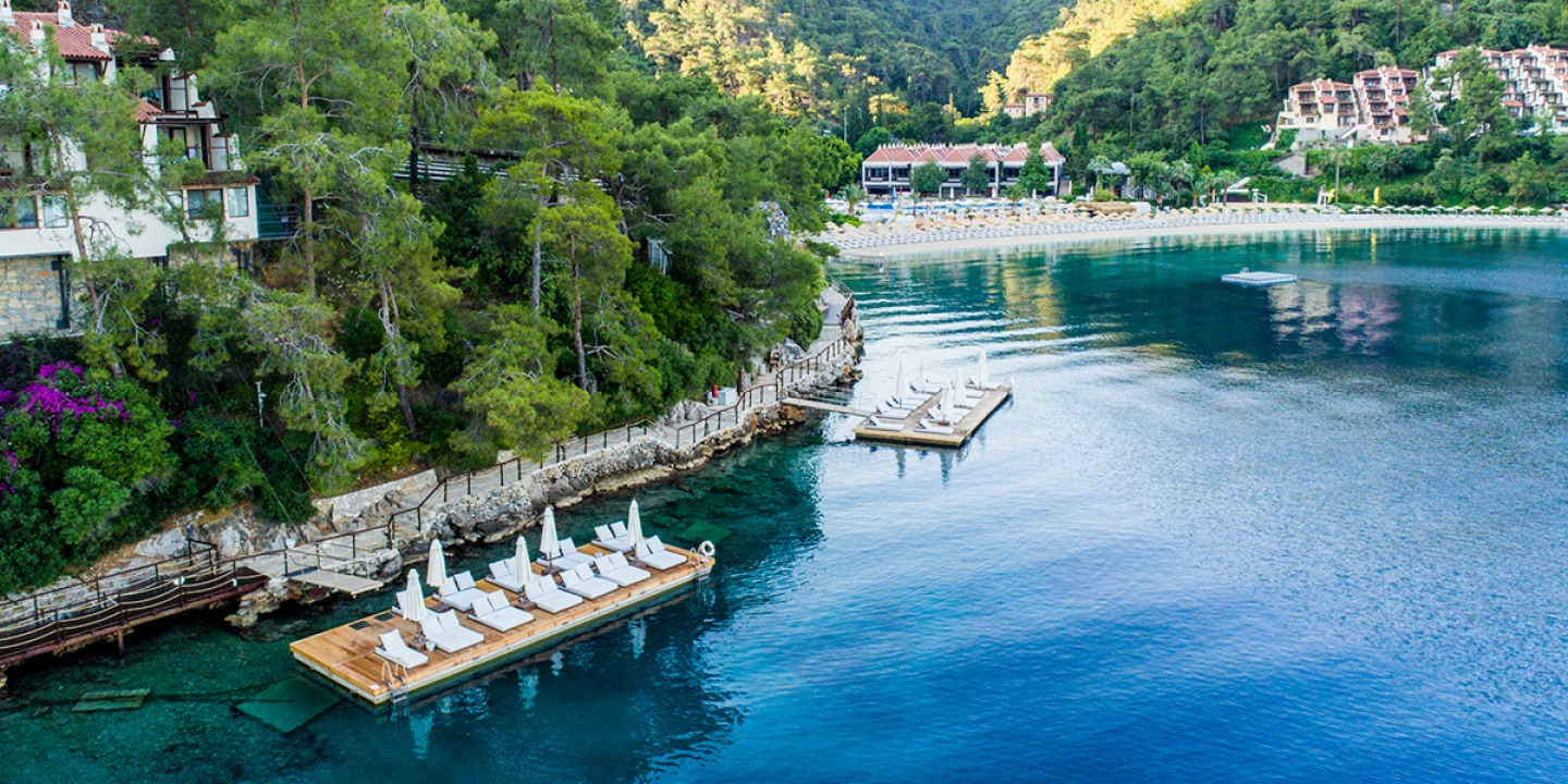 Sun loungers and umbrellas on wooden floating pontoons