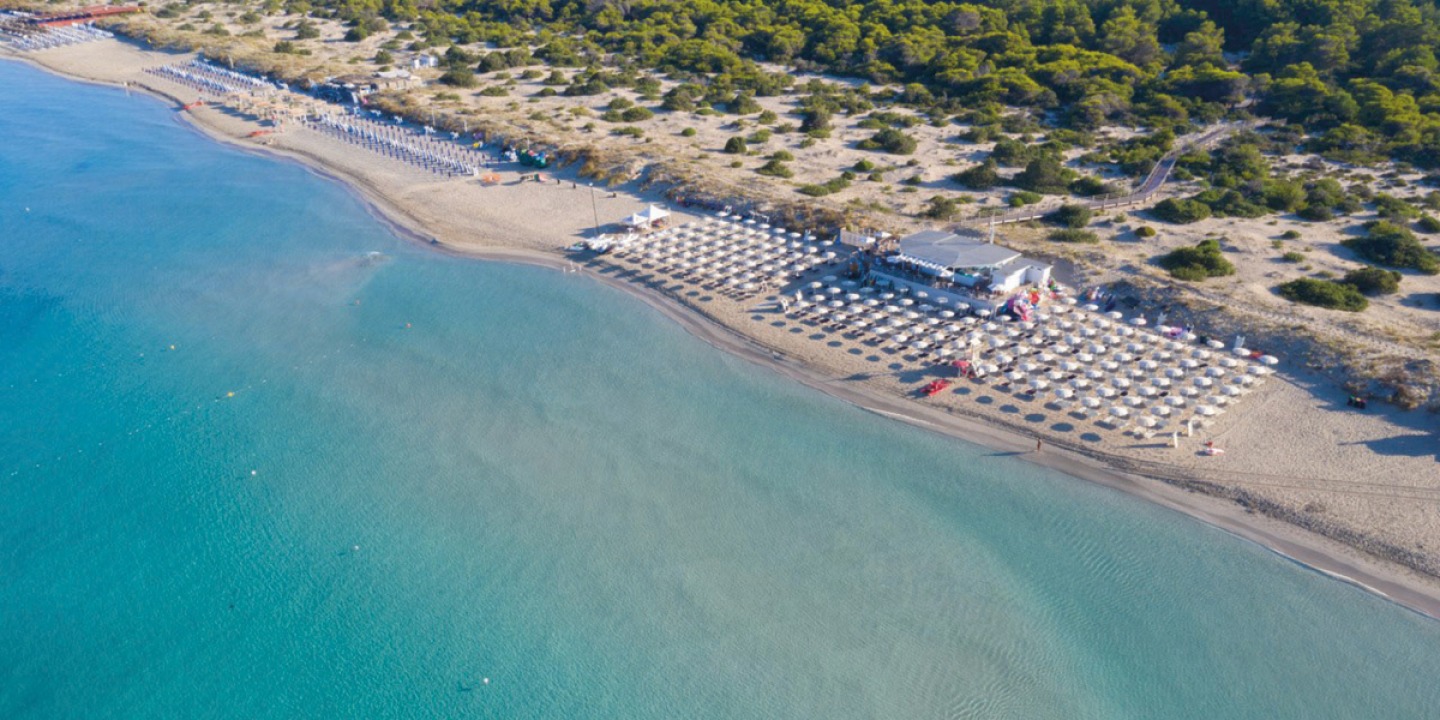 Ariel view of a large resort with loungers set out on beach
