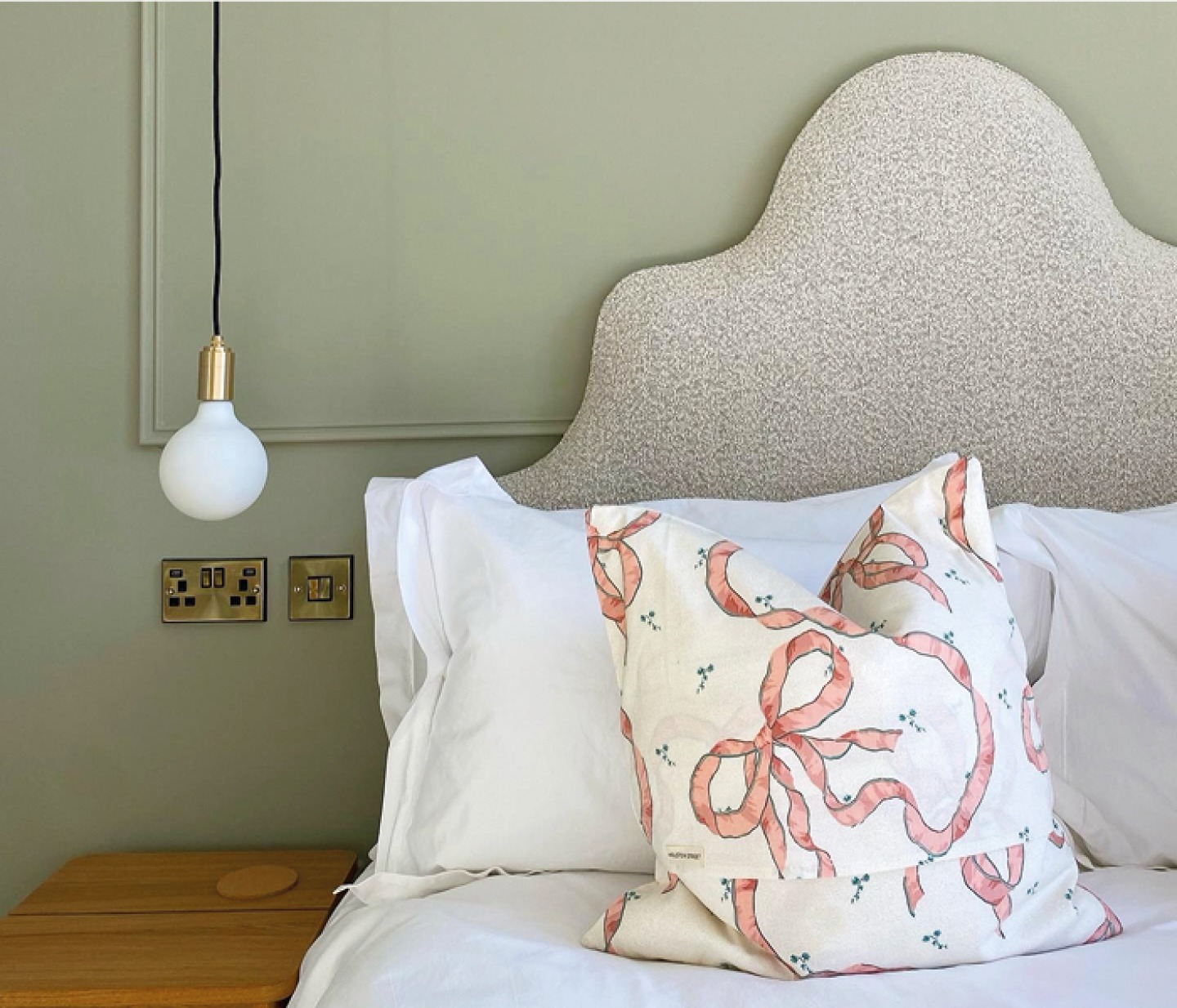 shaped headboard with white bedding and single pendant light at Railway House York