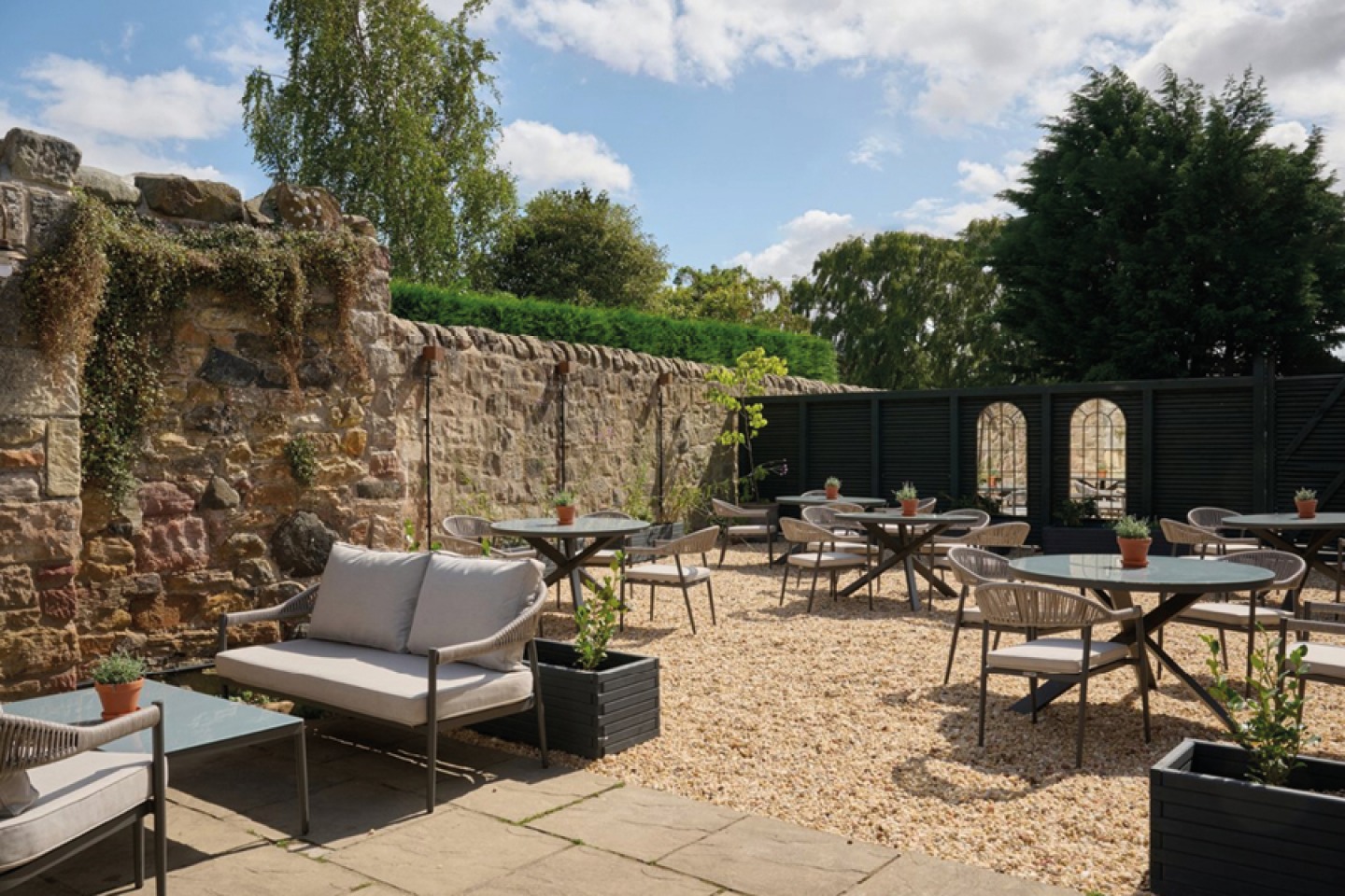 Courtyard with stone walls and modern seating