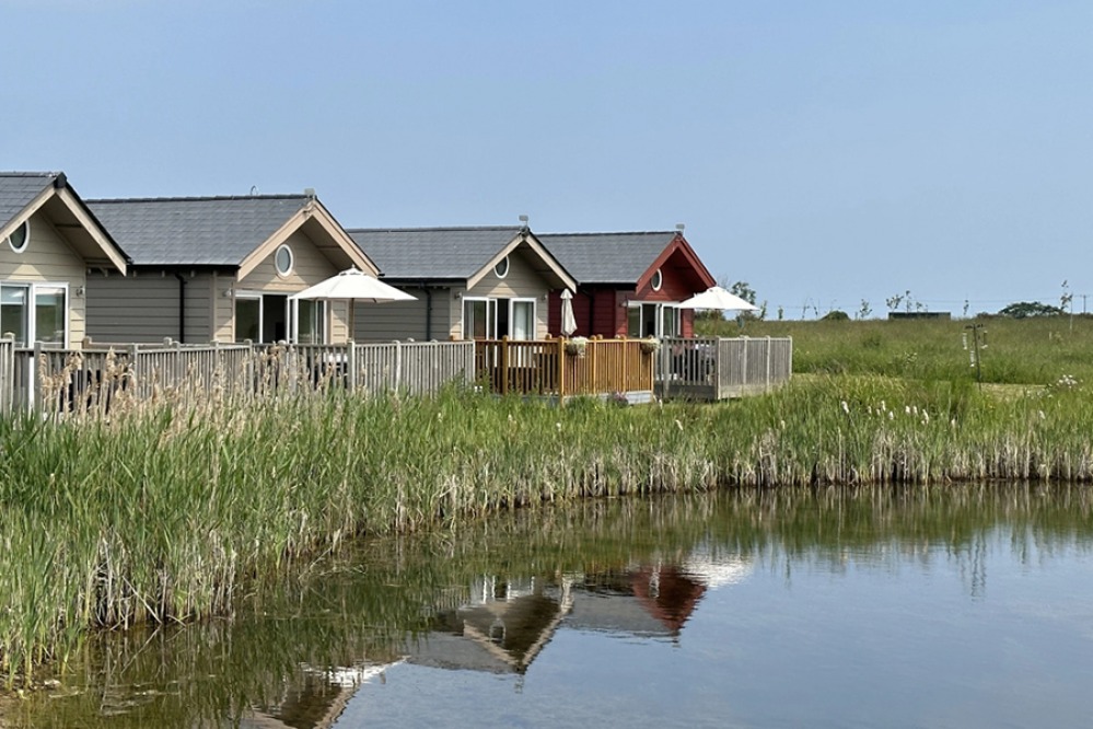 Wooden holiday lodges around a lake