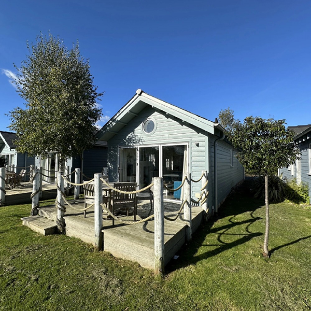 Holiday cabin with wooden deck and seating area