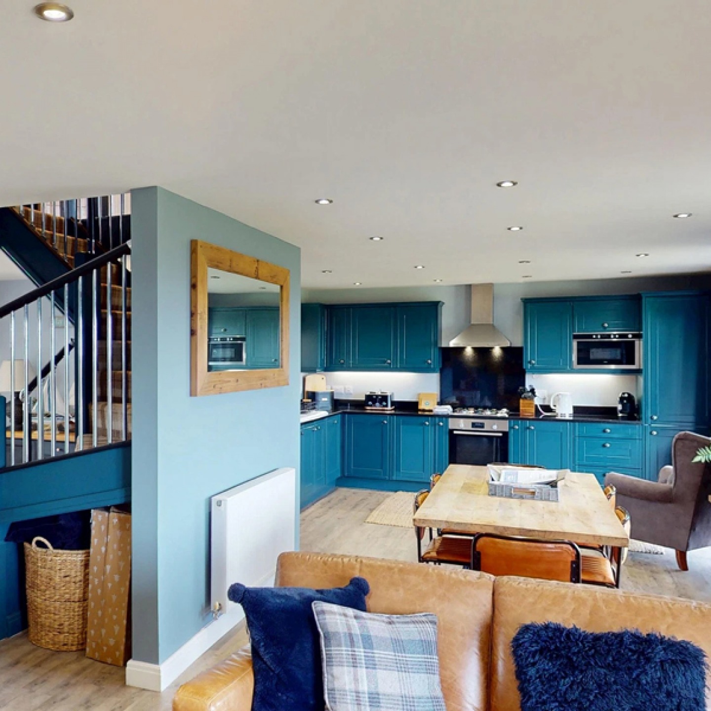 Open plan kitchen and living are decorated in sea blues