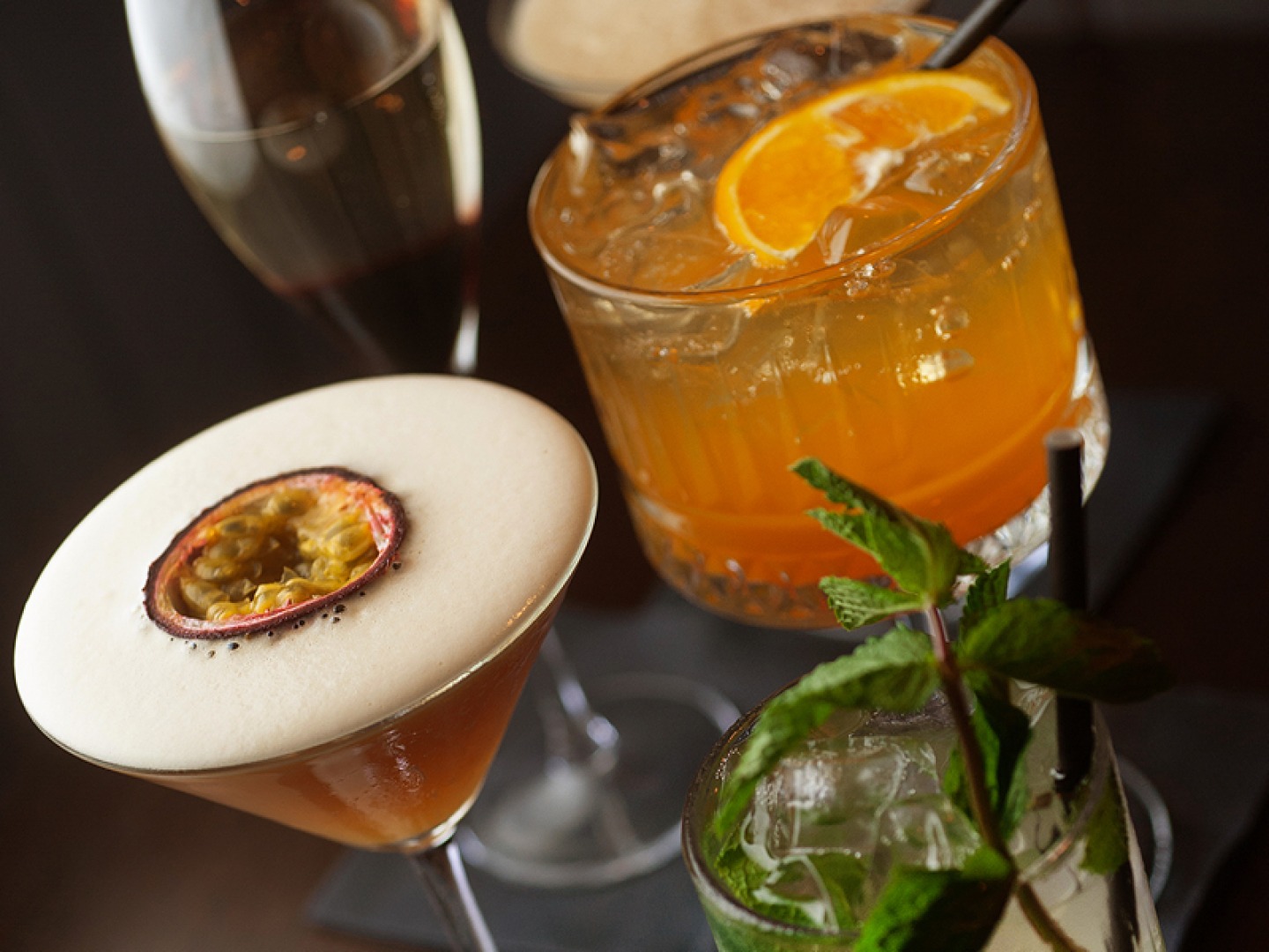 collection of 3 different cocktails and a glass of fiz