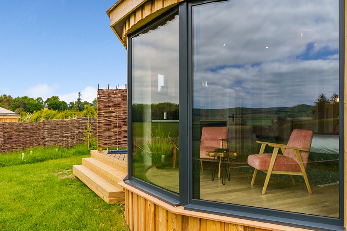 Large picture windows of a glamping pod