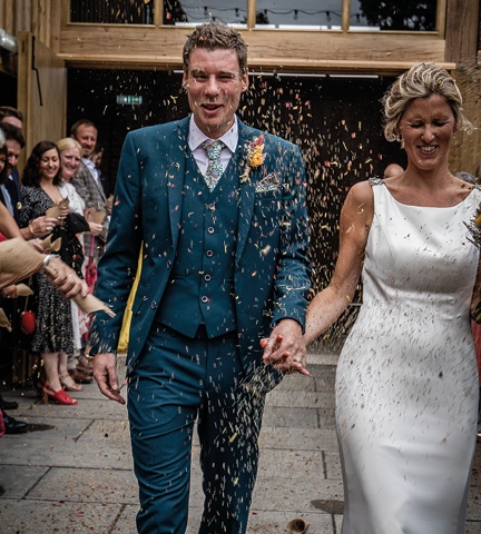 bride and groom covered in confetti