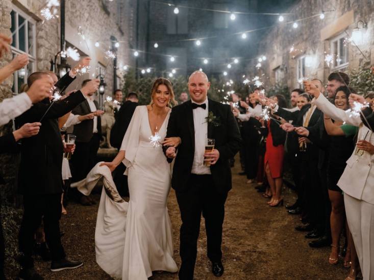 a couple on their wedding day with sparklers