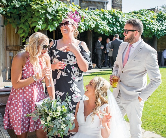 bride sitting down laughing with guests