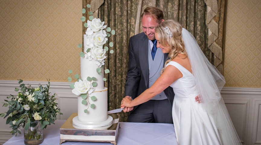 bride and groom cutting the cake