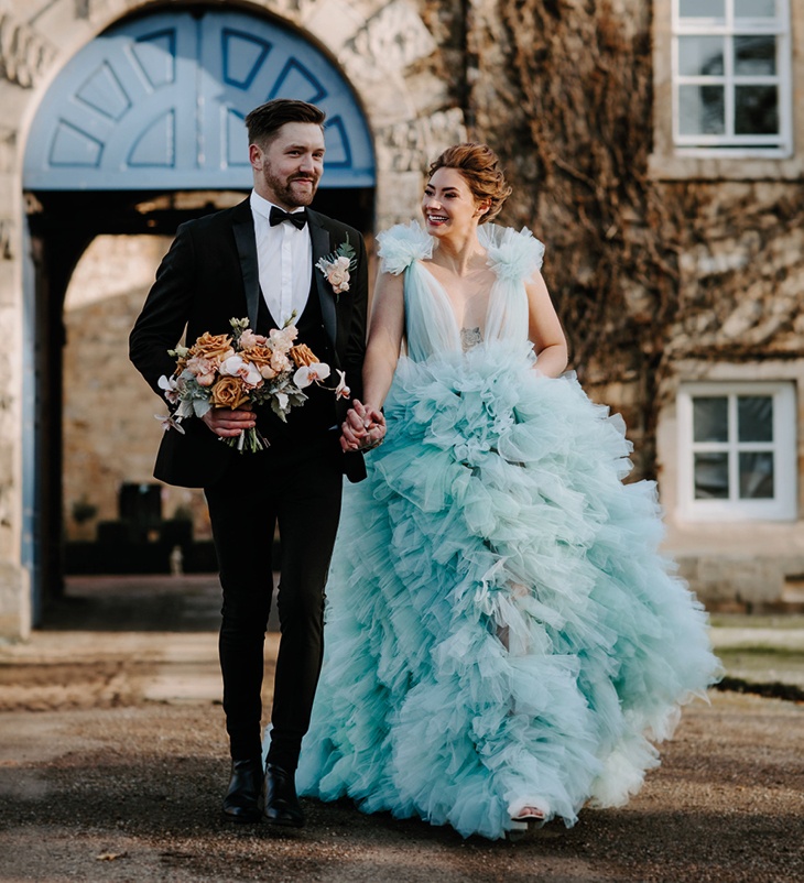 bride and groom walking hand in hand
