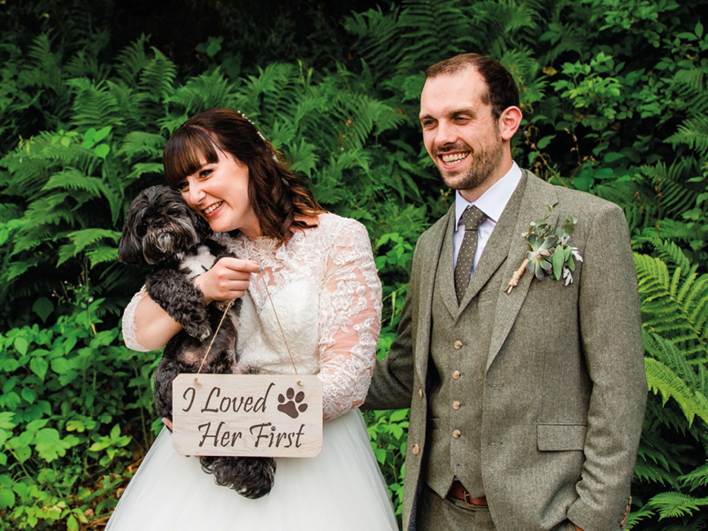 bride and groom holding their dog