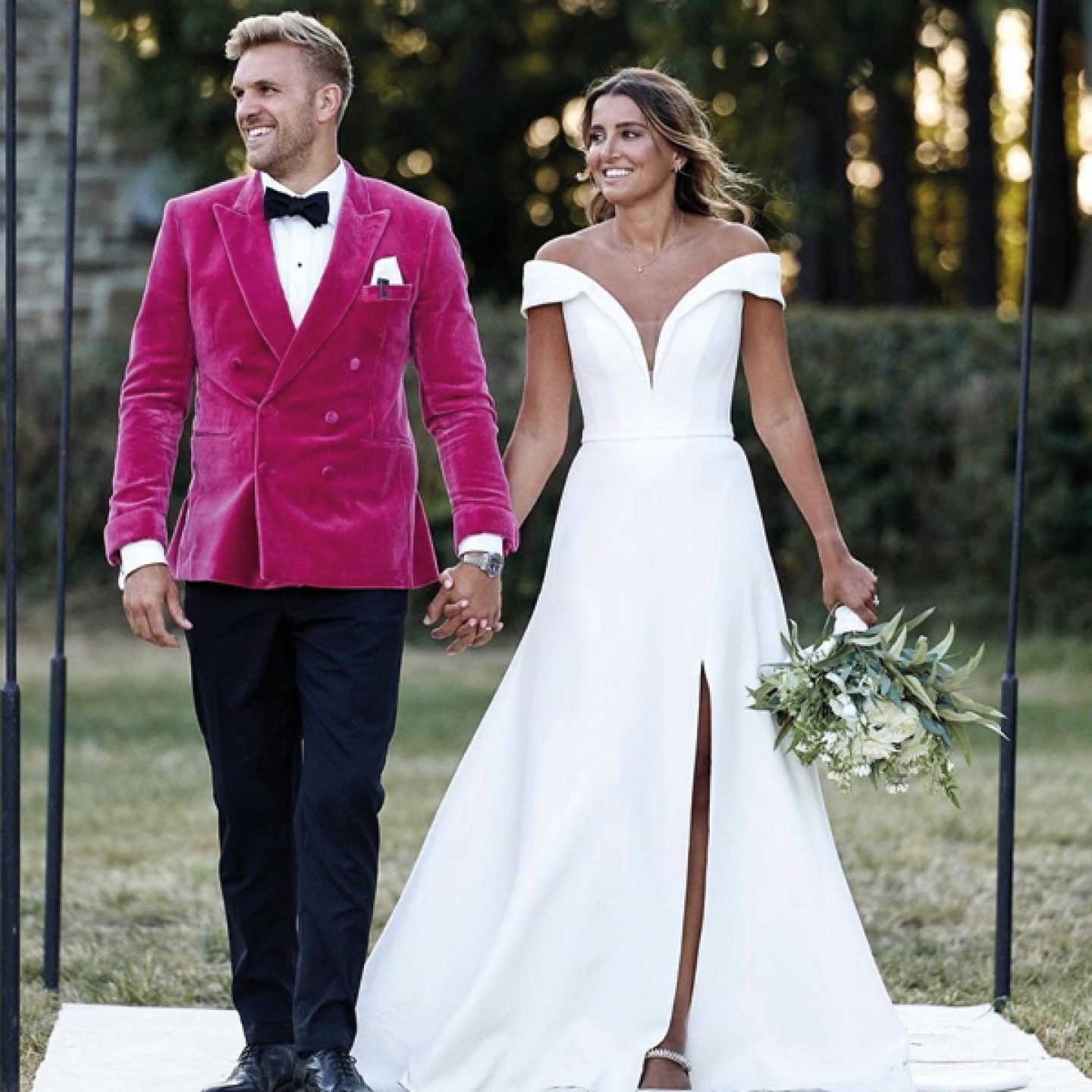 Bride in a white dress and Groom in a pink velvet jacket