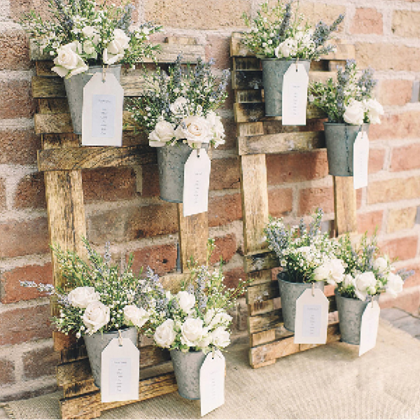flowers in tin pots fixed to a wooden crate