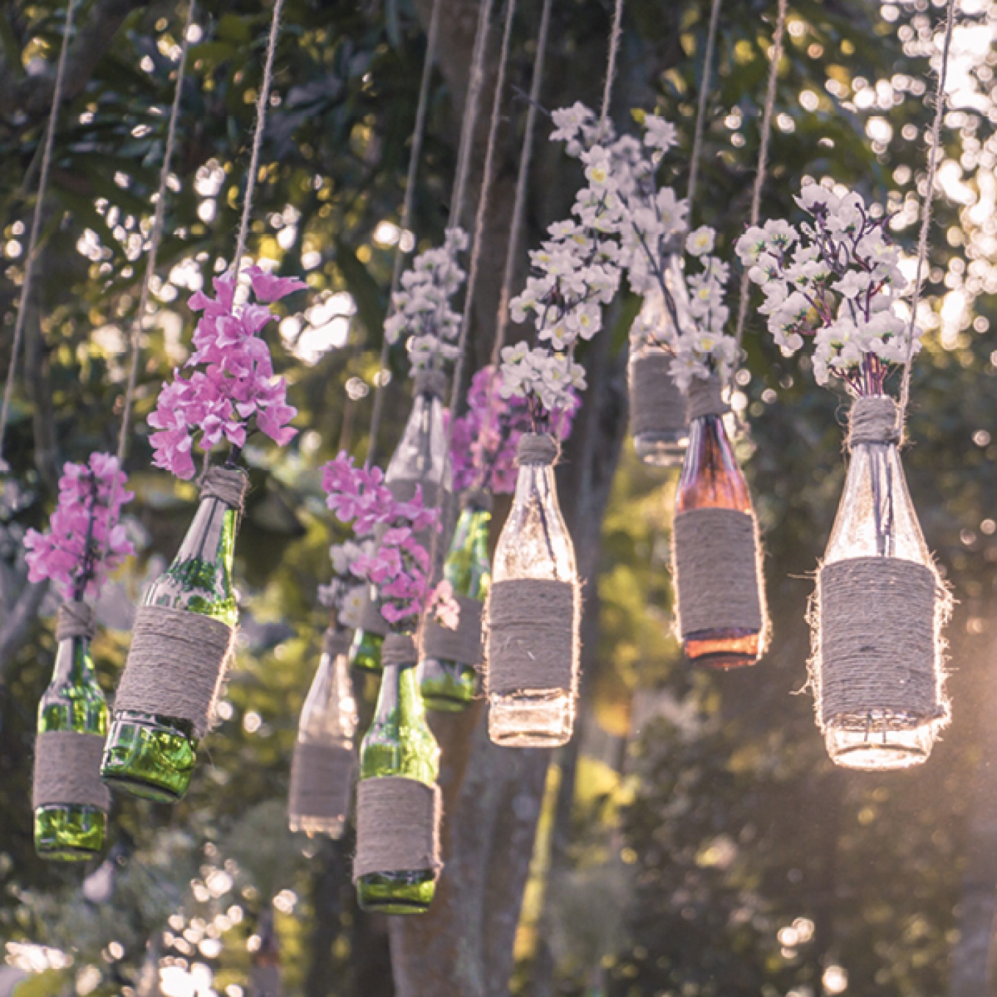 hanging floral feature with glass, flowers and twine