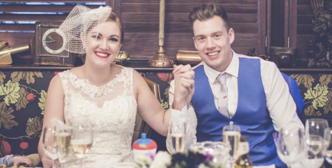 Bride and Groom hold hands smiling