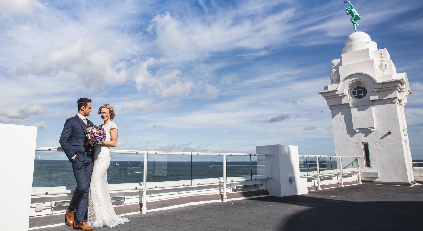 Bride and Groom posing for Photographs with views out to see