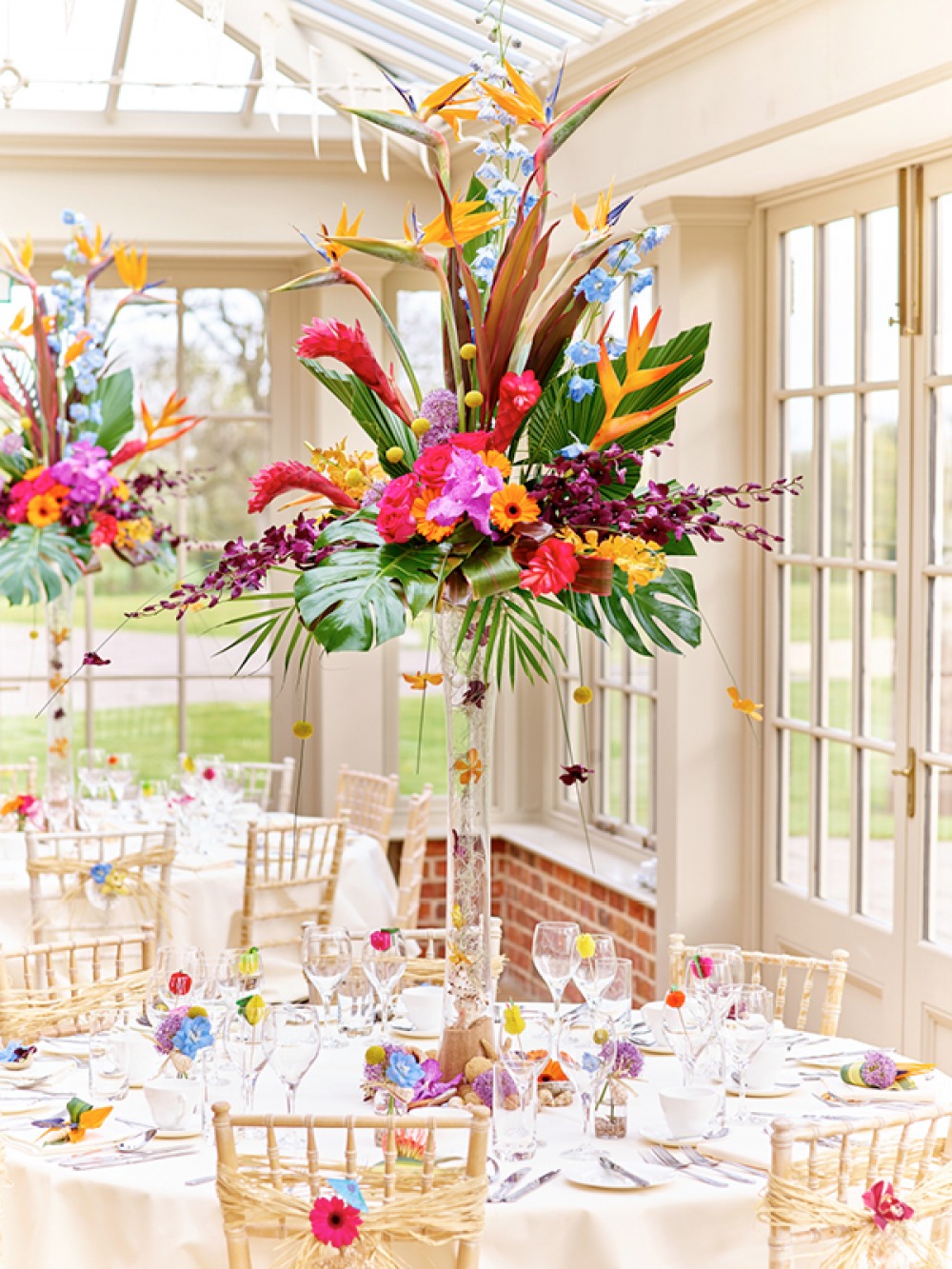 Tall colourful centre piece on wedding breakfast table