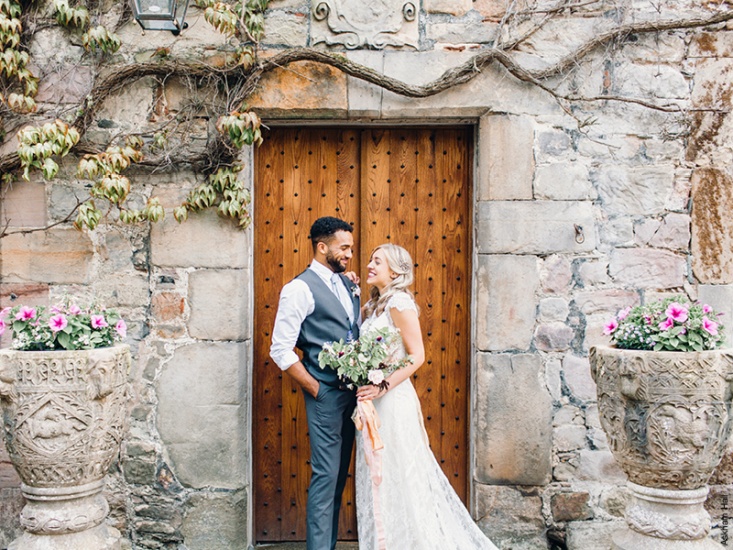 Married couple posing in front of doorway