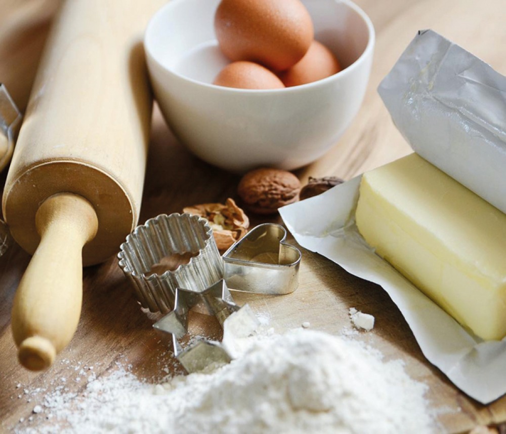 butter, eggs flour, cookie cutters and rolling pin