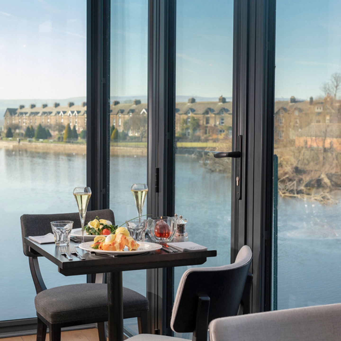 Table set with food and wine overlooking River Wharf