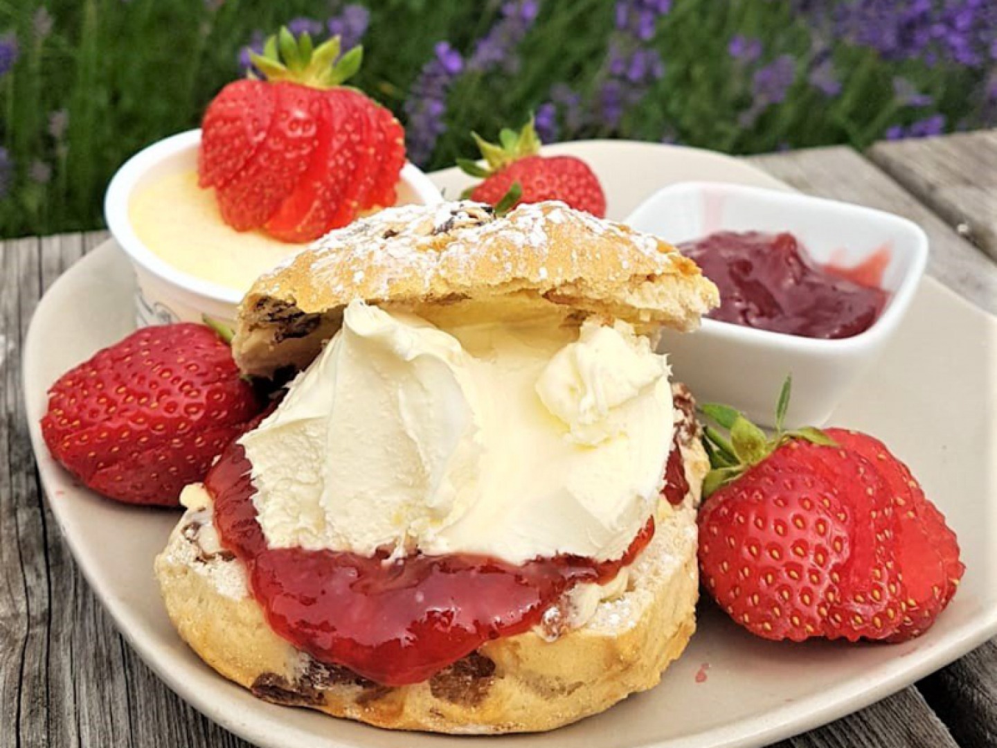 scone with cream, jam and strawberries