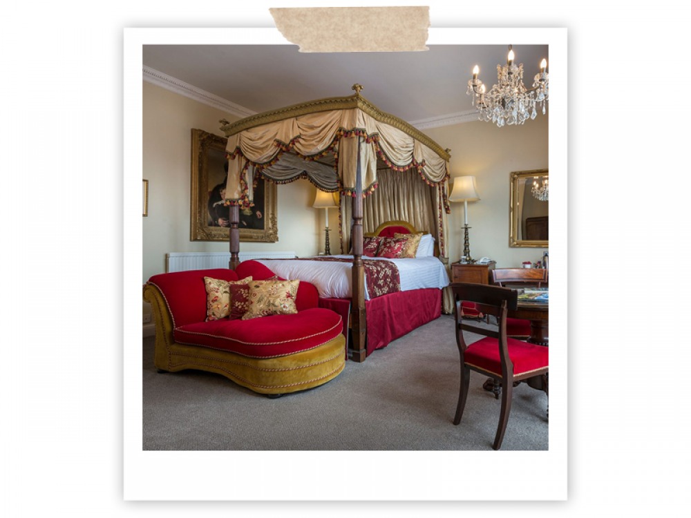 traditional bedroom with four poster bed, styled with gold and red