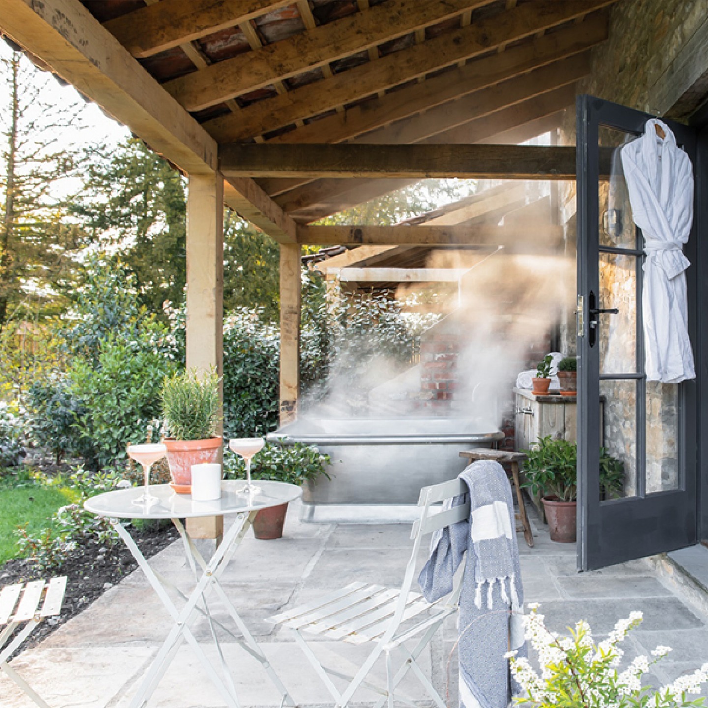Outdoor hot tub on terrace with cocktails at Middleton Lodge