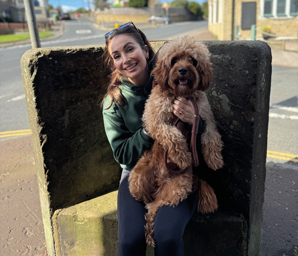 Roxy with her dog on her lap 