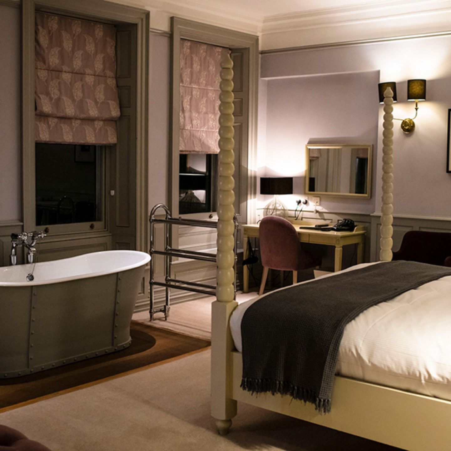 bedroom with four poster bed and bath tub at Houndgate Townhouse Hotel