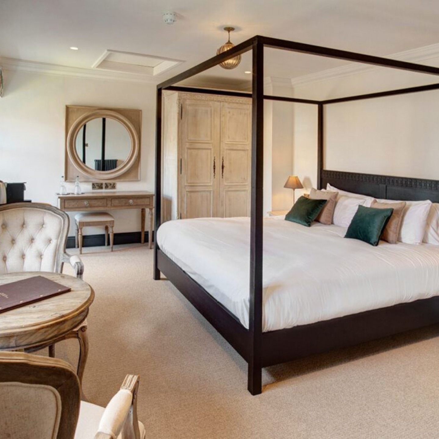 white and cream bedroom with a dark coloured bed