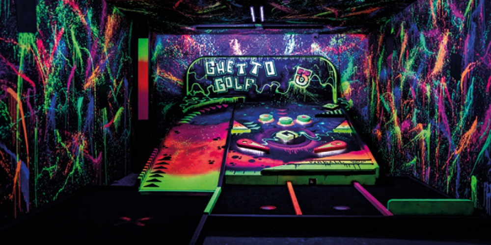 Crazy golf with florescent paint and writing on the walls