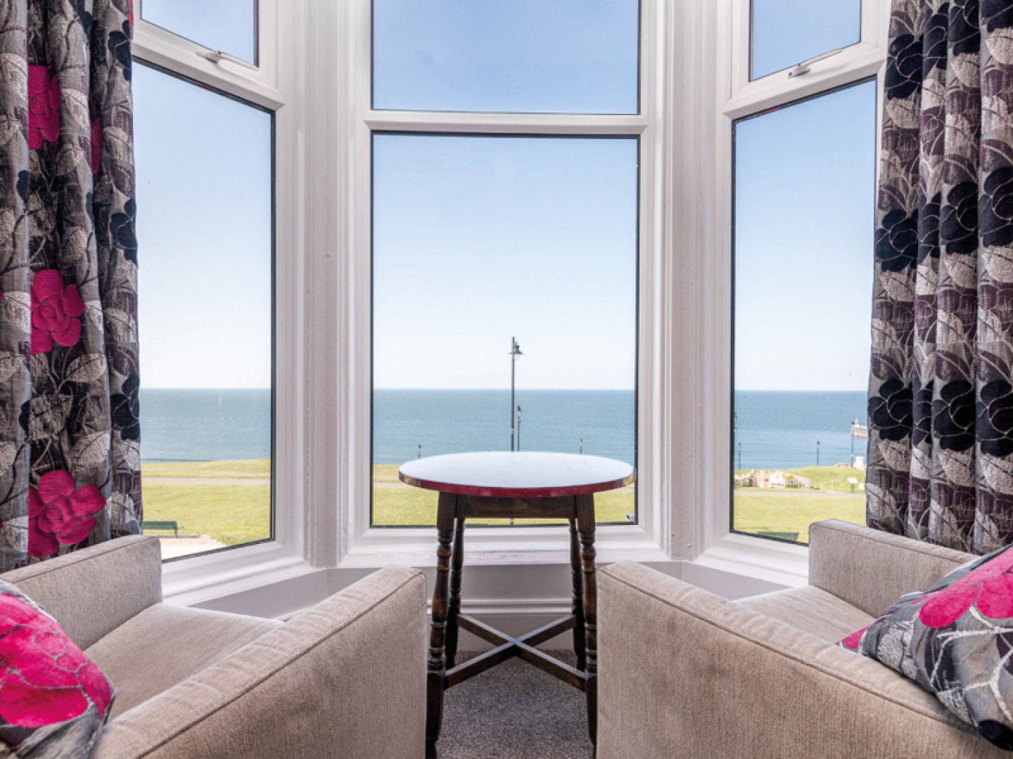 Bay window with two chairs looking out to sea