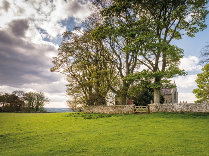 church in a walled area in a field