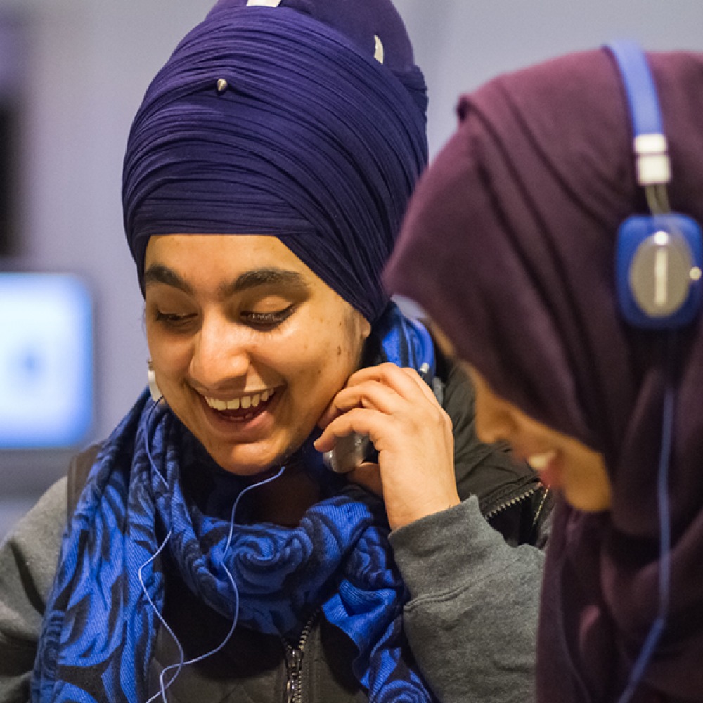 two girls using headphones