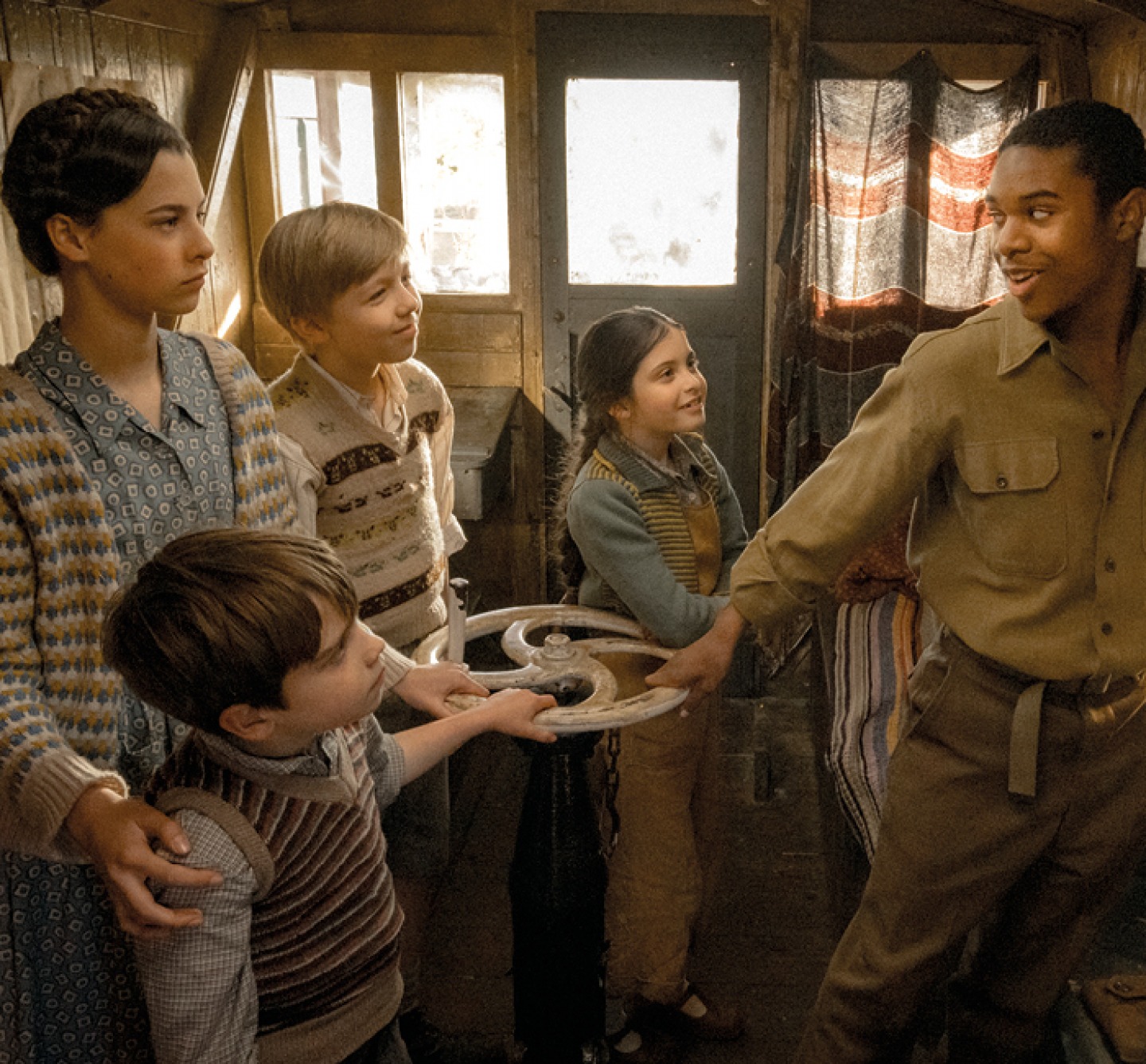 cast in scene turning a wheel